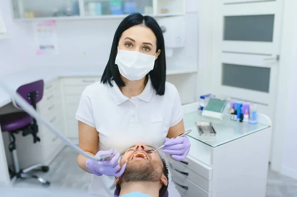 Young man at the dentist. Dental care, taking care of teeth. Picture with copy space for background