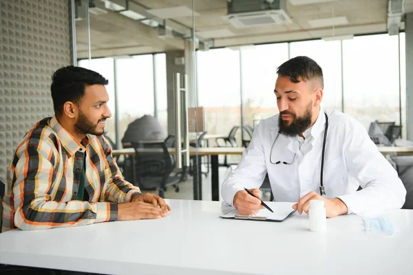 An Indian man is being examined by a doctor. Arab doctor. Health concept.