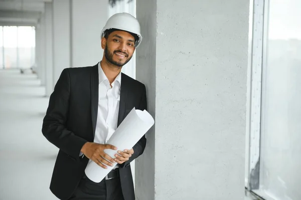 architecture, construction business and building concept - happy smiling indian male architect in helmet