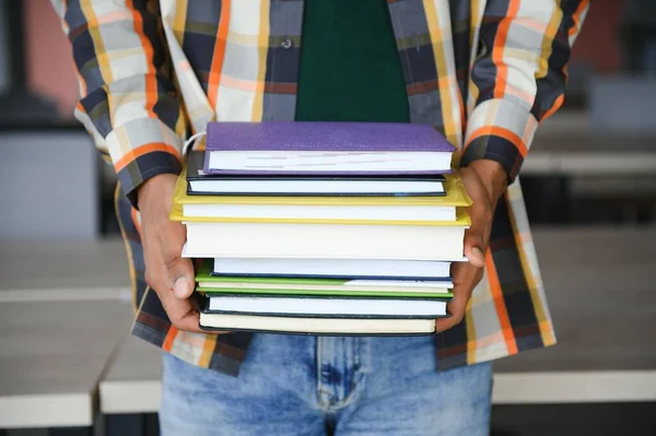 stock image indian student with books at university.