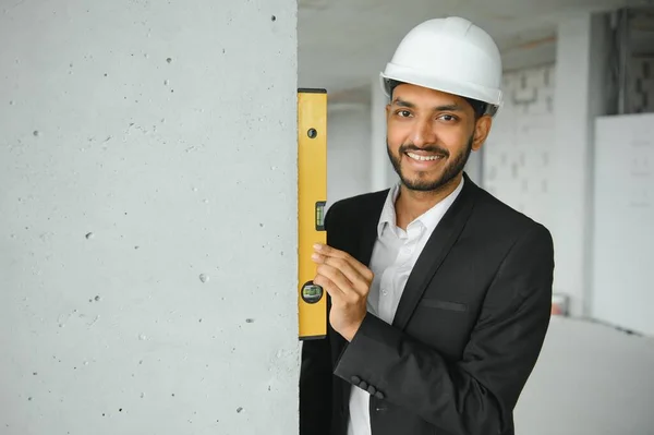 Portrait of a Indian engineer posing at the camera.