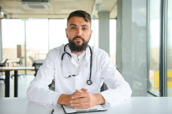 Portrait of a young Arab doctor in the clinic. Healthcare concept.