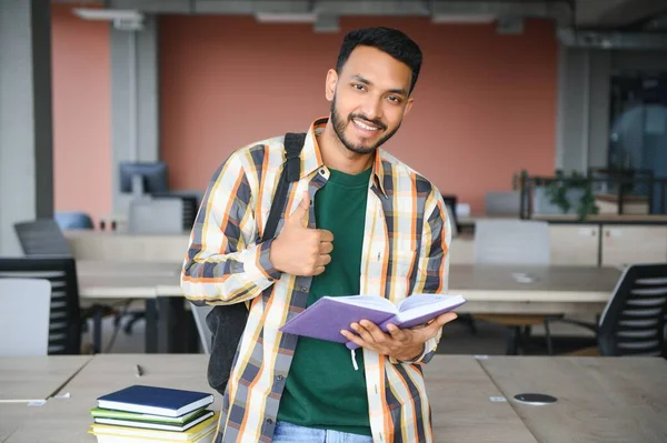indian student with books at university.