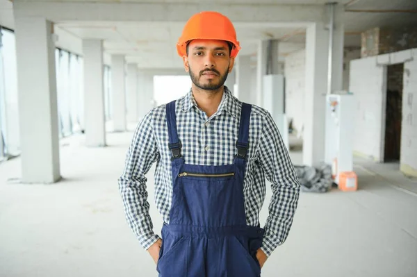 A migrant worker poses for a photo on a city centre construction site in Singapore. The SE Asian city state has a significant migrant worker population.