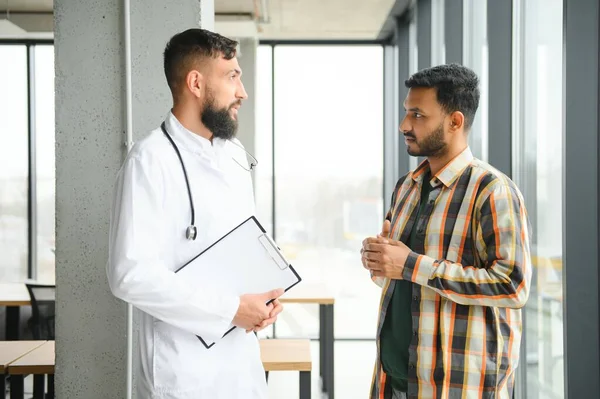 An Indian man is being examined by a doctor. Arab doctor. Health concept.