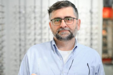 Glasses check, senior vision and elderly man at a consulting optometry clinic for wellness. Happy, smile and old face with lens, frame and eyewear choice in a store for help getting a prescription