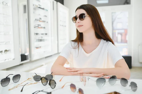 stock image Front view of optician holding sunglasses pairs.