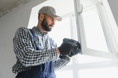 Ev üzerine beyaz plastik upvc pencere kurma işçisi