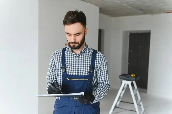 stock image Young worker making repair in room.