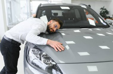 Kafkas asıllı başarılı genç işadamı yeni arabasını kucaklıyor, oto galerisinden pahalı bir araba aldıktan sonra heyecanlanıyor.