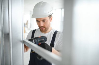 Alçıpan bölmesi için metal profil çerçevesini duvara bağlayın..