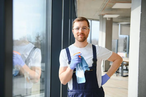 stock image An employee of a professional cleaning service washes the glass of the windows of the building. Showcase cleaning for shops and businesses