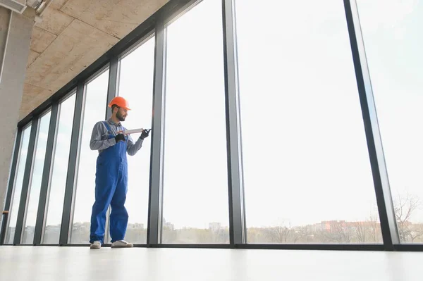 stock image service man installing plastic window