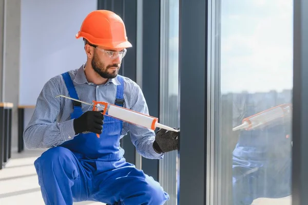 Workers Tube Sealant Suction Lifters Installing Plastic Windows Indoors — стоковое фото