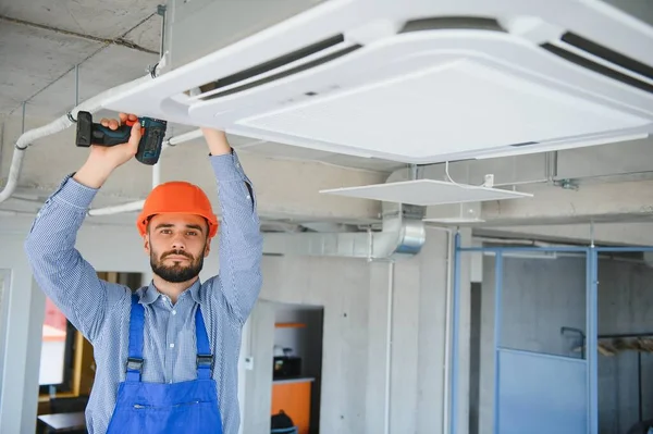 幸せの男性技術者がエアコンの修理 — ストック写真
