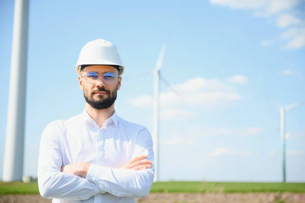 Engineer working at alternative renewable wind energy farm - Sustainable energy industry concept.