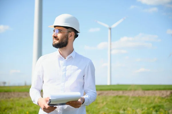 stock image Windmill turbine maintenance engineer standing at wind farm