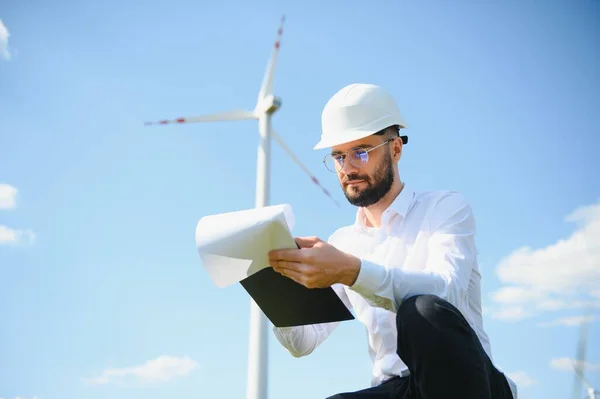 stock image Windmill turbine maintenance engineer standing at wind farm