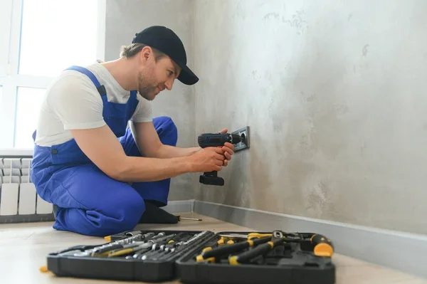 Confident Professional Electrician Uniform Using Screwdriver While Replacing Socket Apartment — Fotografia de Stock