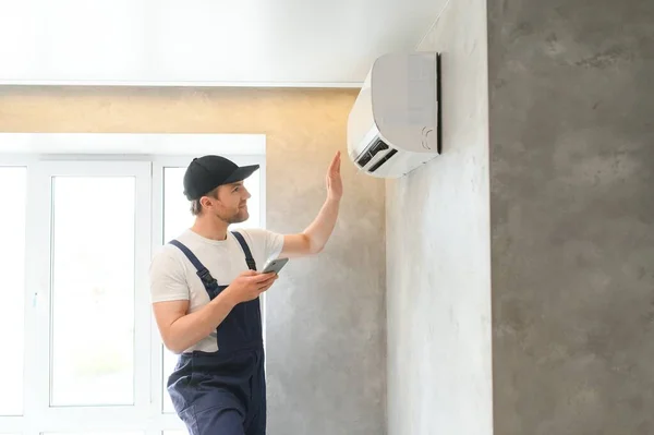 stock image Service man is cleaning, repair and maintenance of air conditioner