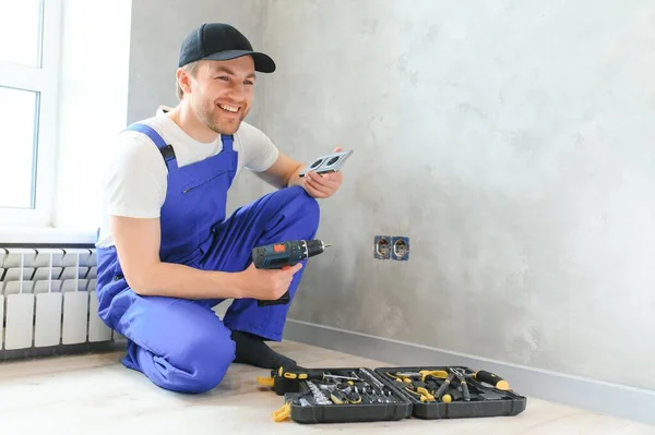 Confident Professional Electrician Uniform Using Screwdriver While Replacing Socket Apartment — Fotografia de Stock