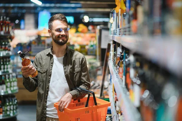 Bir Adam Süpermarketin Rafından Alkollü Içecekler Alır Alkol Almak Için — Stok fotoğraf