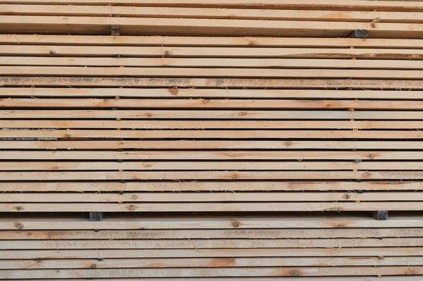 stacked wooden boards in a woodworking industry. stacks with pine lumber. folded edged board. wood harvesting shop. timber for construction