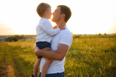 Mutlu baba ve oğul parkın dışında birlikte oynuyorlar. Aile, Babalar Günü, ebeveynlik, aktif yaşam tarzı konsepti