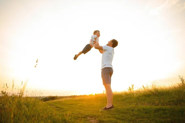 stock image father's day. Dad and son playing together outdoors on a summer. Happy family, father, son at sunset