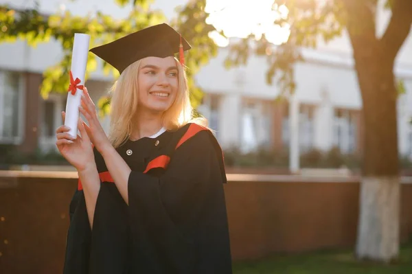 Portrait Enthusiastic Female College Student Graduate Cap Gown Celebrating Holding — Stock Photo, Image