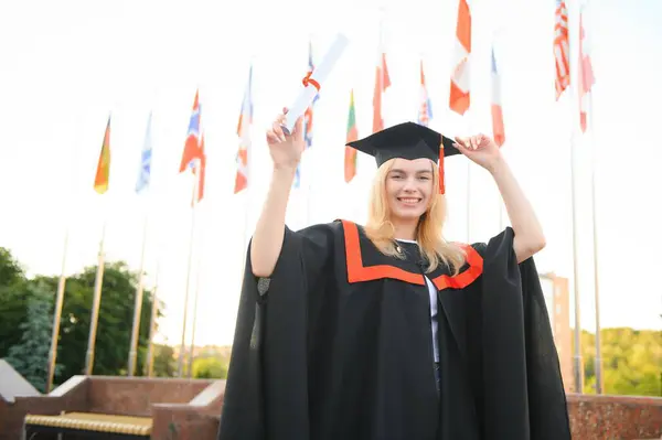 Portrait Enthusiastic Female College Student Graduate Cap Gown Celebrating Holding — Stock Photo, Image