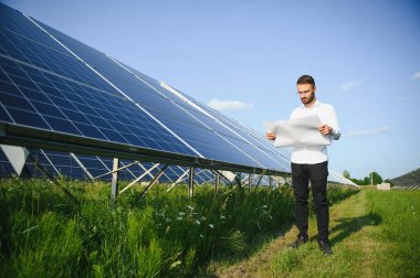 Solar power plant. Engineer on a background of photovoltaic panels. Science solar energy.