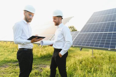 engineer and businessman planing new ecology project. around solar panel