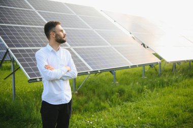 Solar power plant. Engineer on a background of photovoltaic panels. Science solar energy.