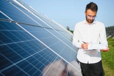 Solar power plant. Engineer on a background of photovoltaic panels. Science solar energy.