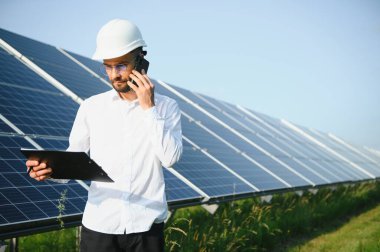 Solar power plant. Engineer on a background of photovoltaic panels. Science solar energy.