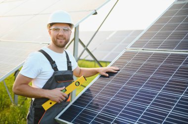 Dışarıda güneş panelleri kuran işçiler