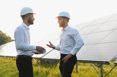 engineer and businessman planing new ecology project. around solar panel