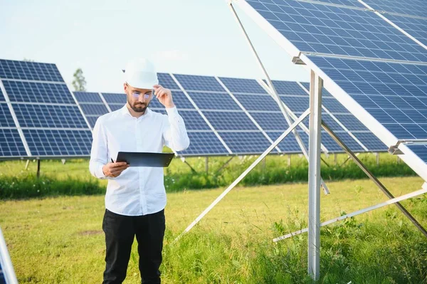 stock image Male worker solar power plant on a background of photovoltaic panels