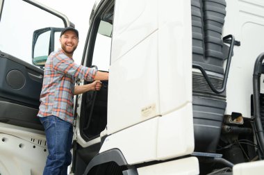 Kafkas erkek kamyon şoförü dinlenme tesisinde araçtan iniyor.