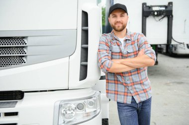 Portrait of trucker standing by his truck ready for driving. Driver occupation. Transportation services. clipart