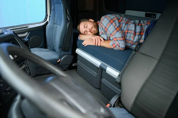 Truck driver sleeping on bed inside truck cabin interior. Trucker lifestyle