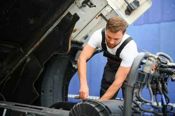 stock image Semi Truck Maintenance. Caucasian Truck Service Worker in His 30s Performing Scheduled Recall Maintenance