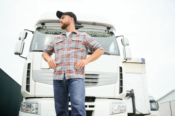 Proud Professional Trucker Standing in Front of His Truck. Trucking and Transportation Theme