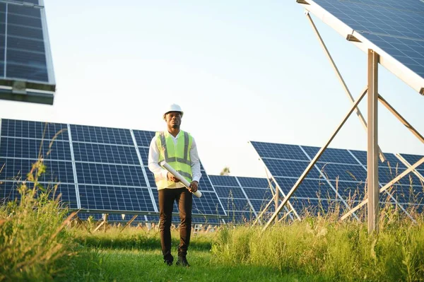 Photovoltaic Green Energy Technology. Worker At Solar Panel Plant.