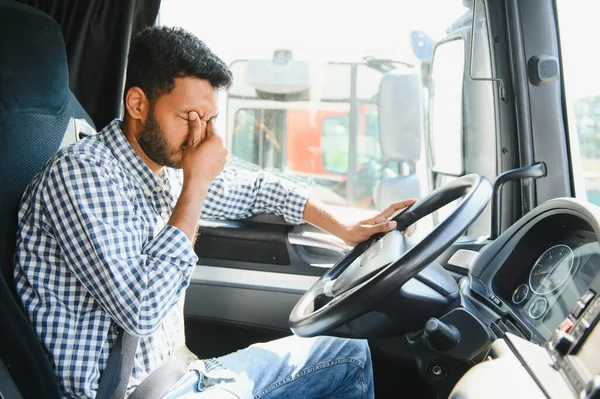 Exhausted truck driver falling asleep on steering wheel. Tiredness and sleeping concept.