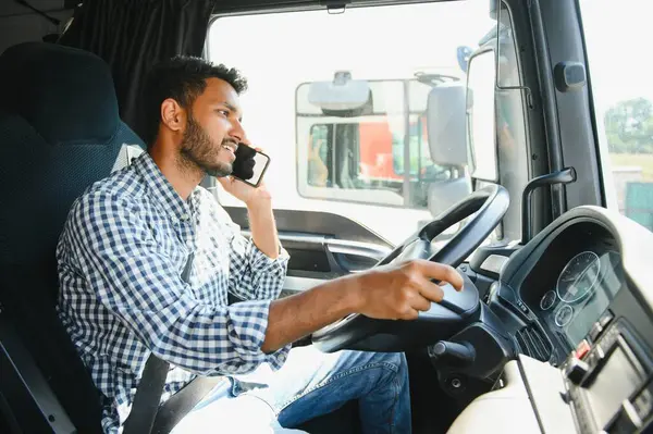 stock image Indian truck driver tending a client on the phone.