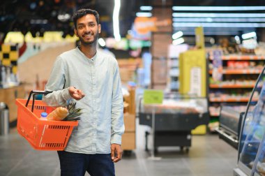 Man at grocery store products.