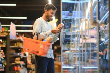 Man at grocery store products.