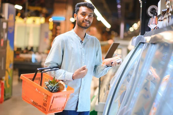 portrait of indian male in grocery with positive attitude.